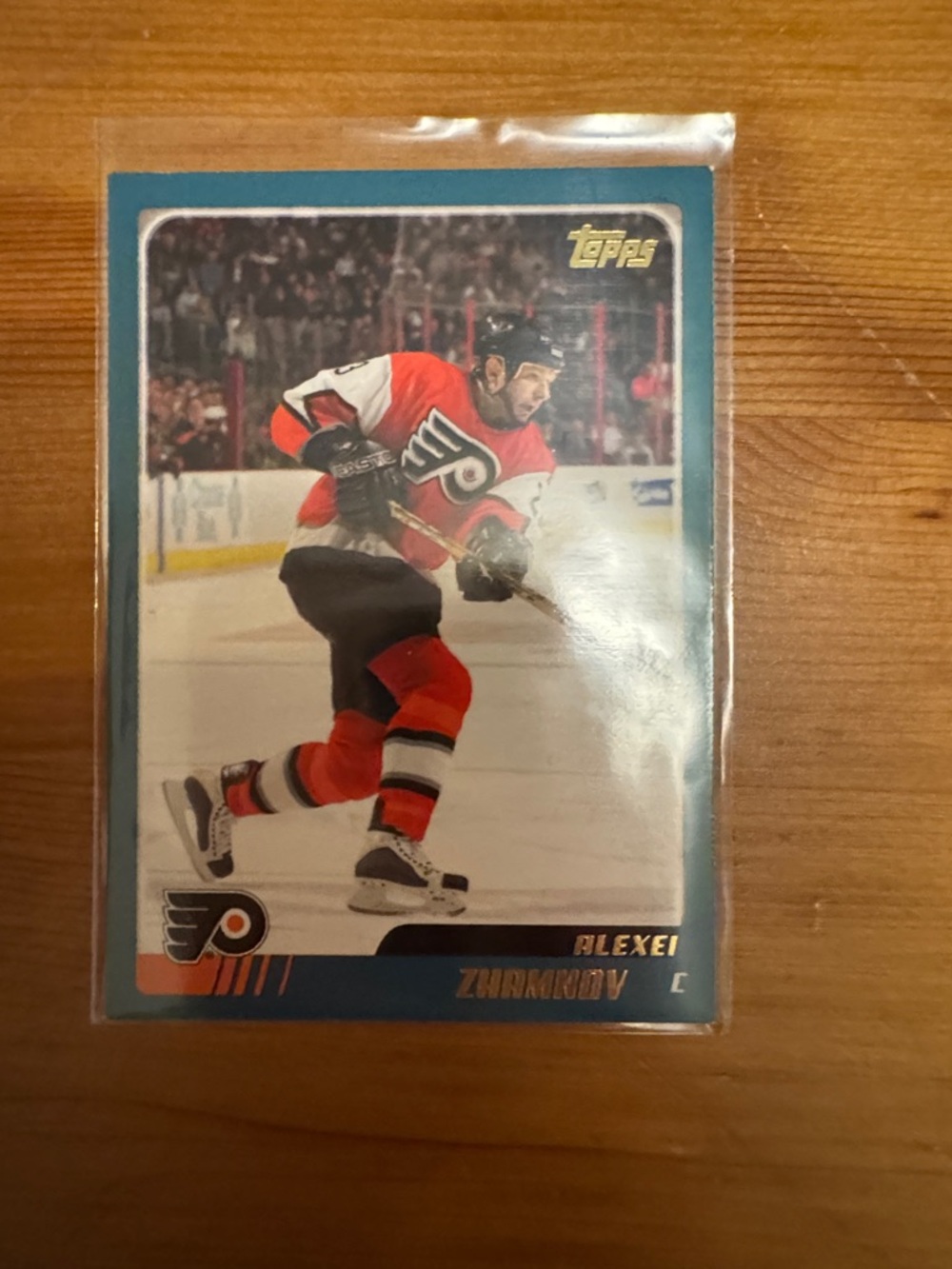 Topps Hockey Card with Teal Border and Red/Black Uniform